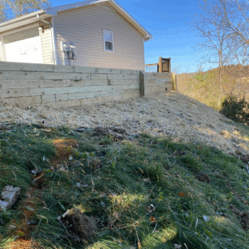 Wooden retaining wall landscape installation