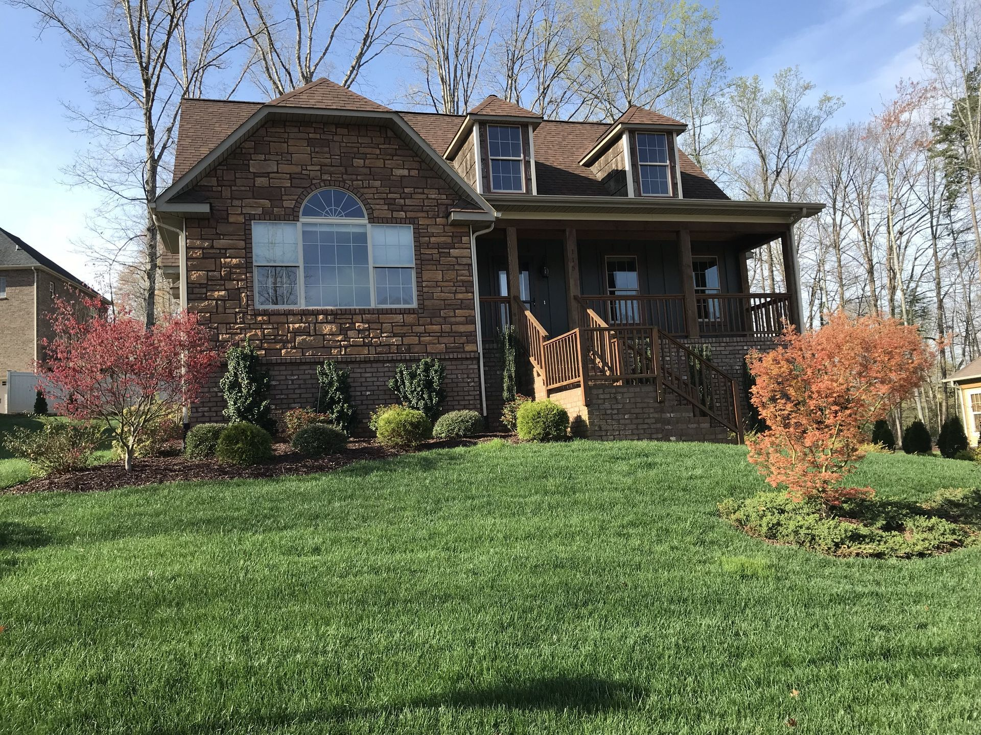 Brick home with landscaped lawn