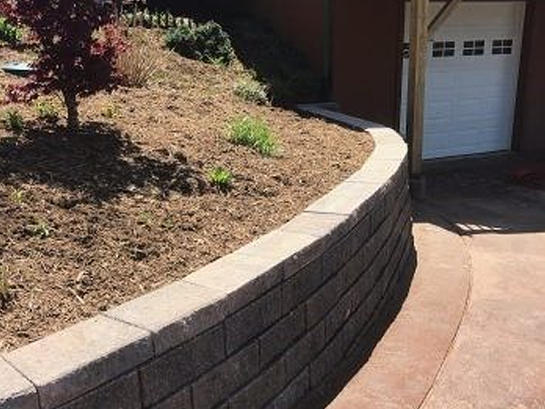 Brick retaining wall near garage