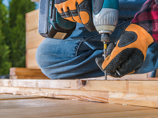 Carpenter using power drill woodworking