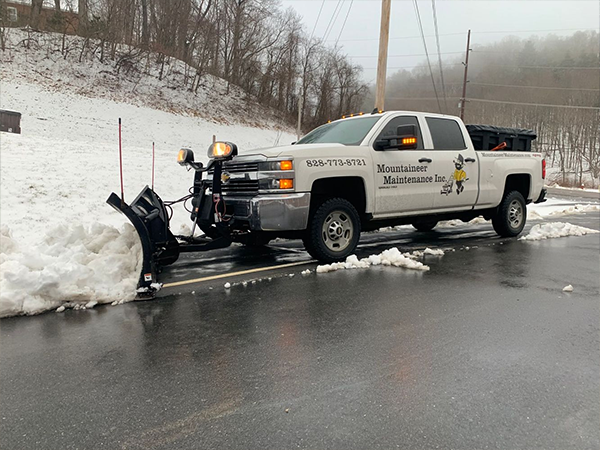Truck plowing snow on road