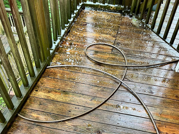 Wet wooden deck with hose